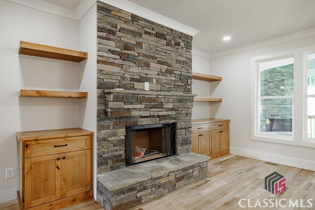 Natural wood built-ins surrounding a stone fireplace